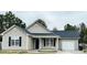 Charming single-story home featuring light siding, black shutters, and a well-maintained front yard at 104 Ginger Cir, Selma, NC 27576