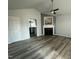 Bright living room featuring a fireplace, ceiling fan, and views into kitchen at 104 Ginger Cir, Selma, NC 27576