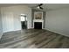 Bright living room featuring a fireplace, ceiling fan, and views into kitchen at 104 Ginger Cir, Selma, NC 27576