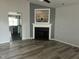 Cozy living room with a fireplace, modern flooring, and neutral color scheme at 104 Ginger Cir, Selma, NC 27576