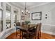 Dining room with hardwood floors, modern chandelier, and a large window at 105 Sunstone Dr, Cary, NC 27519