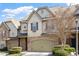 Charming townhome featuring a two-car garage, stone accents, and well-maintained landscaping at 105 Sunstone Dr, Cary, NC 27519