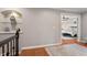 Upstairs hallway showcasing hardwood floors and access to main bedroom at 105 Sunstone Dr, Cary, NC 27519