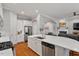 Open concept kitchen featuring stainless appliances, granite counters and access to Gathering room at 105 Sunstone Dr, Cary, NC 27519