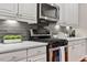 Updated kitchen featuring stainless steel appliances, gas cooktop, and modern backsplash at 105 Sunstone Dr, Cary, NC 27519
