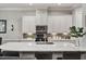 Modern kitchen featuring stainless appliances, white cabinets, and an oversized island at 105 Sunstone Dr, Cary, NC 27519