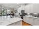 Bright modern kitchen with white cabinetry, island seating and eat-in dining area at 105 Sunstone Dr, Cary, NC 27519