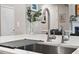 Close up of a kitchen island with stainless faucet and steel sink, and stone countertops at 105 Sunstone Dr, Cary, NC 27519