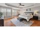 Spacious main bedroom with tray ceiling, large windows, and a cozy seating area at 105 Sunstone Dr, Cary, NC 27519