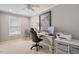 Bright office space with a ceiling fan, natural light, and a printer and computer at 105 Sunstone Dr, Cary, NC 27519