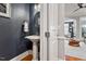 Stylish powder room with pedestal sink and hardwood floors, located off the living area at 105 Sunstone Dr, Cary, NC 27519