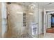 Walk-in shower featuring glass door and stone accents at 105 Sunstone Dr, Cary, NC 27519