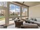 Bright sunroom with seating and large windows, overlooking a tranquil pond and fountain at 105 Sunstone Dr, Cary, NC 27519