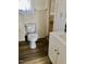This bathroom has vintage tiled walls, a modern toilet and a newer vanity at 1111 Spring Valley Lake Rd, Henderson, NC 27537