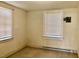 Bedroom features natural light from two windows and baseboard heating at 1111 Spring Valley Lake Rd, Henderson, NC 27537