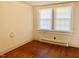 Bedroom featuring two windows and hardwood flooring at 1111 Spring Valley Lake Rd, Henderson, NC 27537