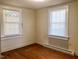 Bedroom featuring two windows and hardwood flooring at 1111 Spring Valley Lake Rd, Henderson, NC 27537