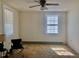 Bedroom featuring two windows, ceiling fan, and hardwood floors at 1111 Spring Valley Lake Rd, Henderson, NC 27537