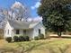 Charming single-Gathering home with white siding and mature landscaping on a sunny day at 1111 Spring Valley Lake Rd, Henderson, NC 27537