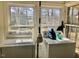 Laundry room with two windows and a pair of older model washer and dryer sets at 1111 Spring Valley Lake Rd, Henderson, NC 27537