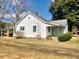 View of a single Gathering home with a carport and mature plantings near the back of the home at 1111 Spring Valley Lake Rd, Henderson, NC 27537