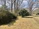 Lush yard with mature trees offers a private and serene outdoor space at 1111 Spring Valley Lake Rd, Henderson, NC 27537