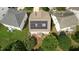 Aerial view of home featuring solar panels, a brick patio, and mature trees at 1112 Jewel Creek Dr, Cary, NC 27519