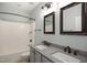 Bathroom with double sink vanity, decorative mirrors, and a shower-tub combo at 1112 Jewel Creek Dr, Cary, NC 27519
