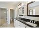 Bathroom with double sink vanity featuring black countertops and white cabinets at 1112 Jewel Creek Dr, Cary, NC 27519