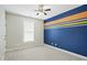 A bedroom featuring a fan, window with blinds, carpet and a blue painted accent wall at 1112 Jewel Creek Dr, Cary, NC 27519