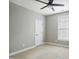 A neutral-colored bedroom features a ceiling fan, window, and door at 1112 Jewel Creek Dr, Cary, NC 27519