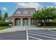 Community clubhouse featuring stone accents, white pillars, and manicured landscaping at 1112 Jewel Creek Dr, Cary, NC 27519