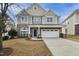 Charming two-story home featuring a brick and siding exterior, with a well-manicured front yard at 1112 Jewel Creek Dr, Cary, NC 27519