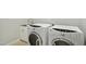 Laundry room area with a white front load washer and dryer and sink at 1112 Jewel Creek Dr, Cary, NC 27519