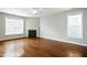 Bright living room featuring hardwood floors, a fireplace, ceiling fan, and lots of windows at 1112 Jewel Creek Dr, Cary, NC 27519