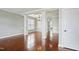 Spacious living room with decorative pillars, hardwood floors, and natural light at 1112 Jewel Creek Dr, Cary, NC 27519