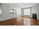 Open-concept living room with hardwood floors, fireplace, and open flow to the kitchen at 1112 Jewel Creek Dr, Cary, NC 27519