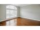 Bright living room featuring hardwood floors, large arched windows, and neutral paint at 1112 Jewel Creek Dr, Cary, NC 27519