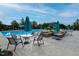 Relax in the community pool area with umbrella tables, landscaping, and comfortable seating at 1112 Jewel Creek Dr, Cary, NC 27519