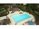 Aerial view of a large pool with surrounding lounge chairs and umbrellas at 1112 Jewel Creek Dr, Cary, NC 27519
