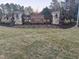 Community entrance featuring stone pillars and a wood fence with signage at 11186 Salers Loop, Middlesex, NC 27557