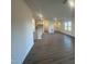 Spacious living room features light wood floors and access to the kitchen and outdoor patio at 11186 Salers Loop, Middlesex, NC 27557