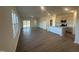 Spacious living room featuring light wood floors and access to the kitchen and outdoor patio at 11186 Salers Loop, Middlesex, NC 27557