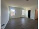 Large bedroom with wood-look flooring, neutral walls, two windows, and an ensuite bathroom at 11186 Salers Loop, Middlesex, NC 27557