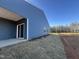 Home's rear exterior features siding, covered patio, newly laid sod, and sliding glass door at 11186 Salers Loop, Middlesex, NC 27557