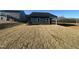 View of home's rear exterior with a small covered patio and newly laid sod at 11186 Salers Loop, Middlesex, NC 27557