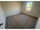 Bright bedroom with neutral carpet and a view of the outdoors at 11844 Ayshire Dr, Middlesex, NC 27557