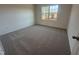 Cozy bedroom with soft carpeting and a window overlooking the front yard at 11844 Ayshire Dr, Middlesex, NC 27557