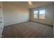 Well-lit bedroom featuring neutral carpet and two windows at 11844 Ayshire Dr, Middlesex, NC 27557