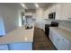Modern kitchen featuring white cabinets, stainless steel appliances, and a large island with quartz countertops at 11844 Ayshire Dr, Middlesex, NC 27557